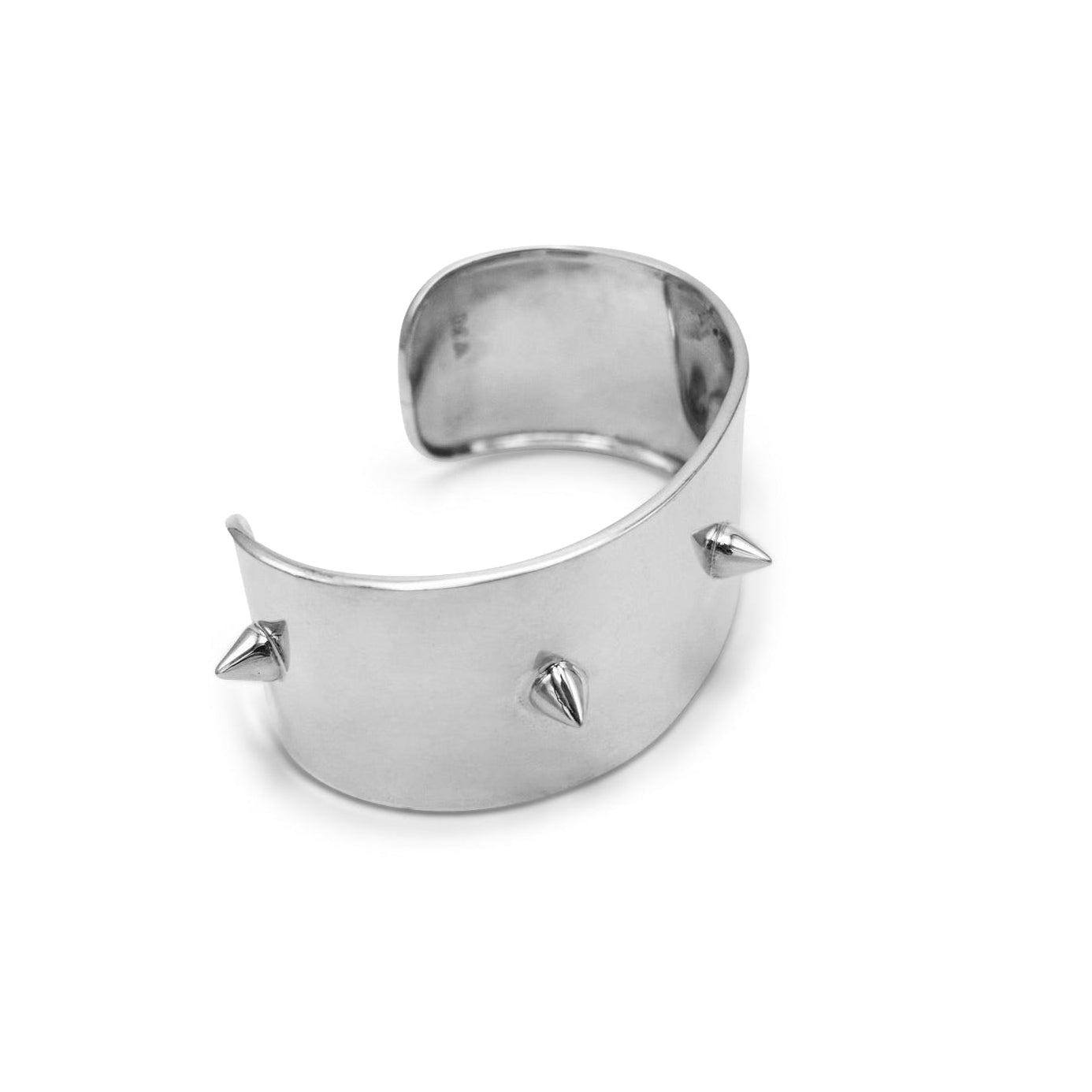 Silver cuff bracelet with spikes on a white background