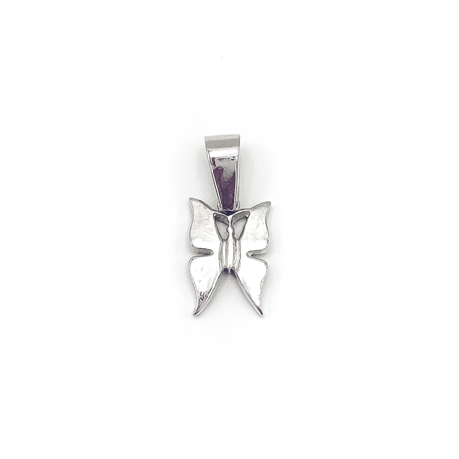 Playful butterfly charm pendant in silver . Flat
