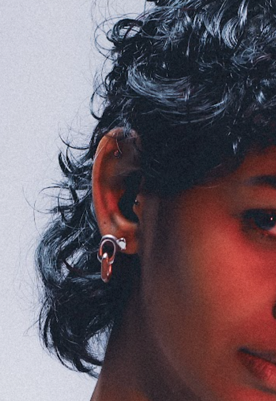 Drop earring featuring diamond-shaped link in silver . ON MODEL