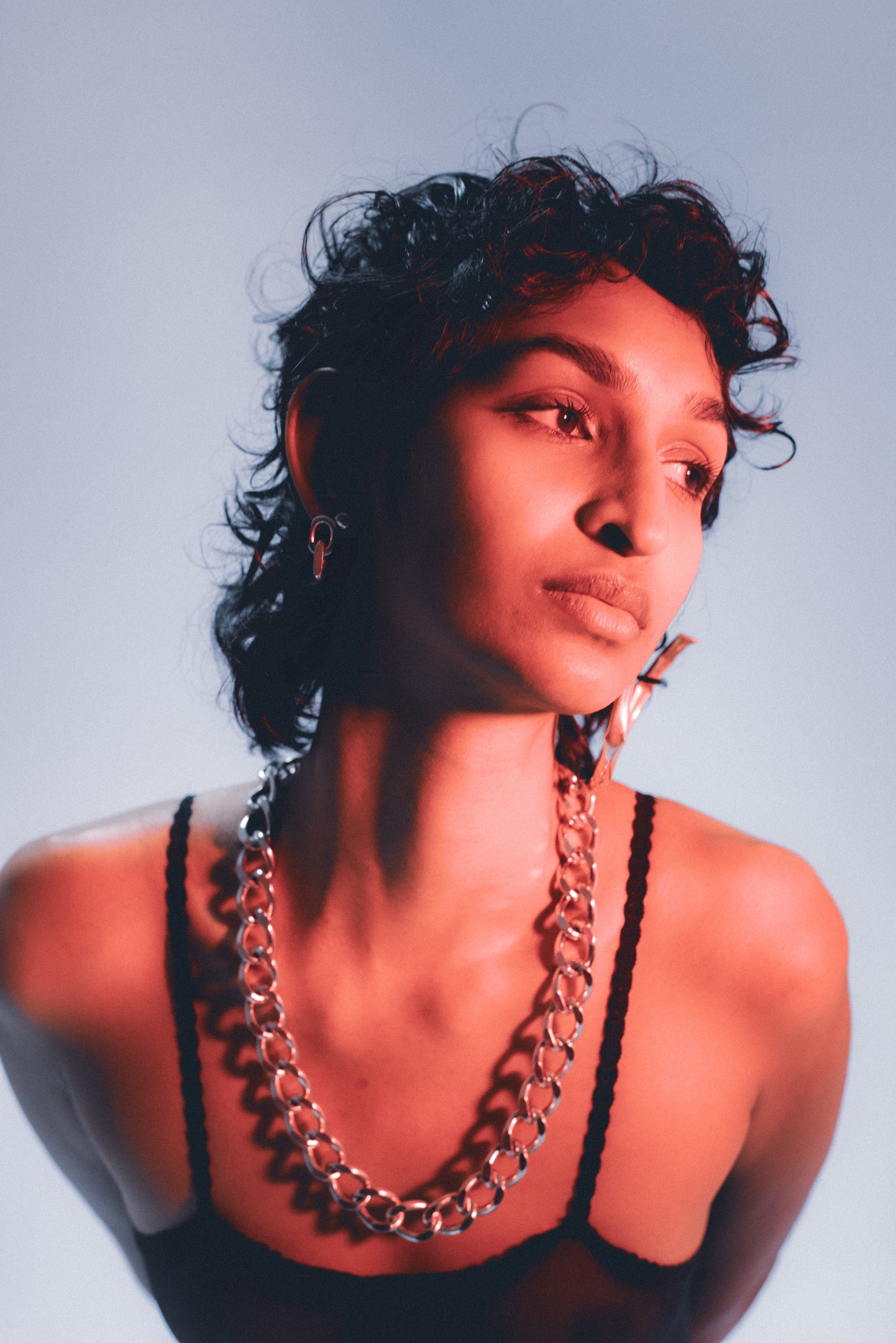 Drop earring featuring diamond-shaped link in silver . ON MODEL