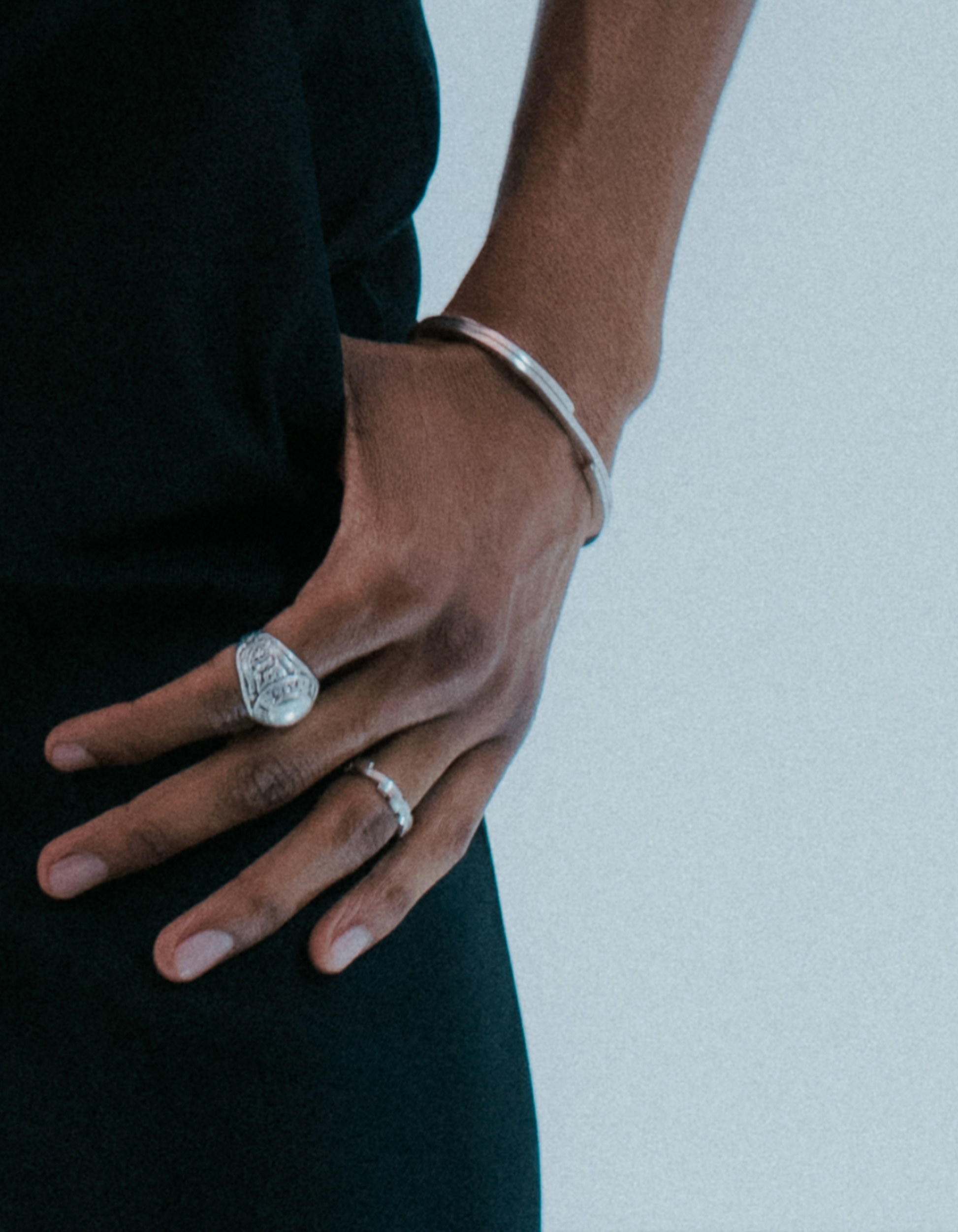 Streamlined flat wrist cuff in solid silver. On model 
