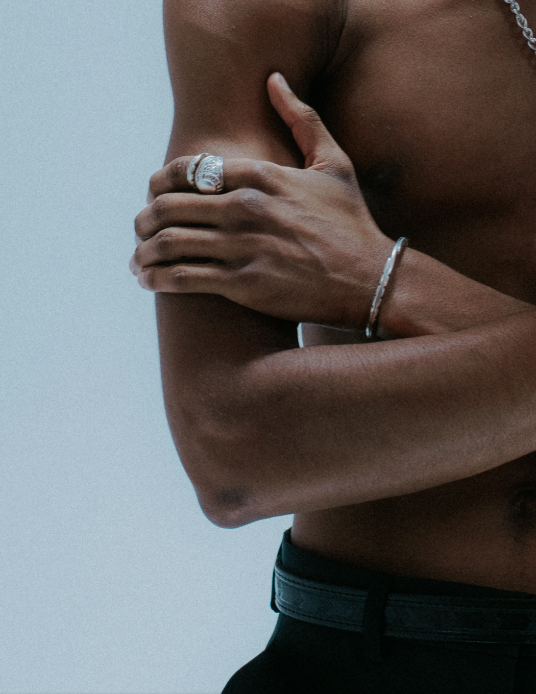 Chunky boxer-style chain bracelet; bold presence.