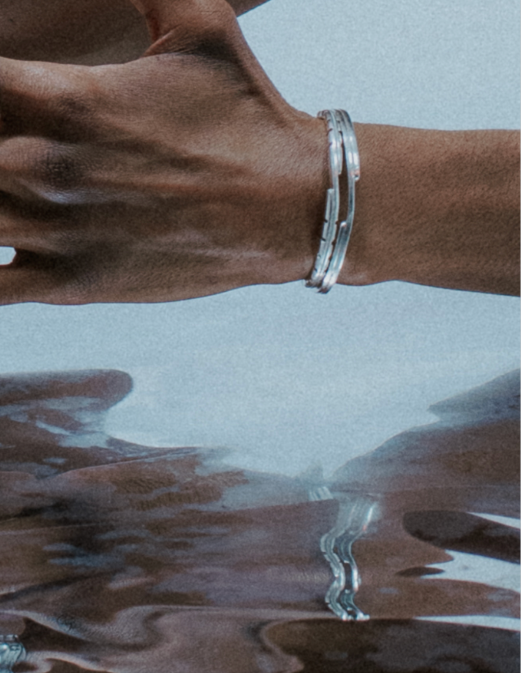 Chunky boxer-style chain bracelet; bold presence .