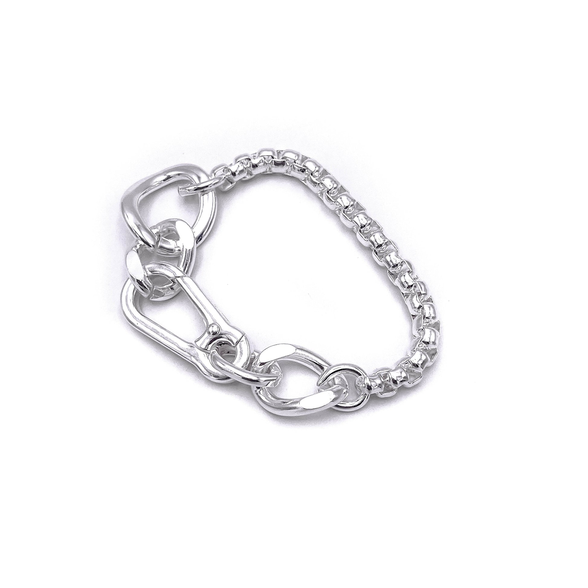 Chunky boxer-style chain bracelet; bold presence . Flats 