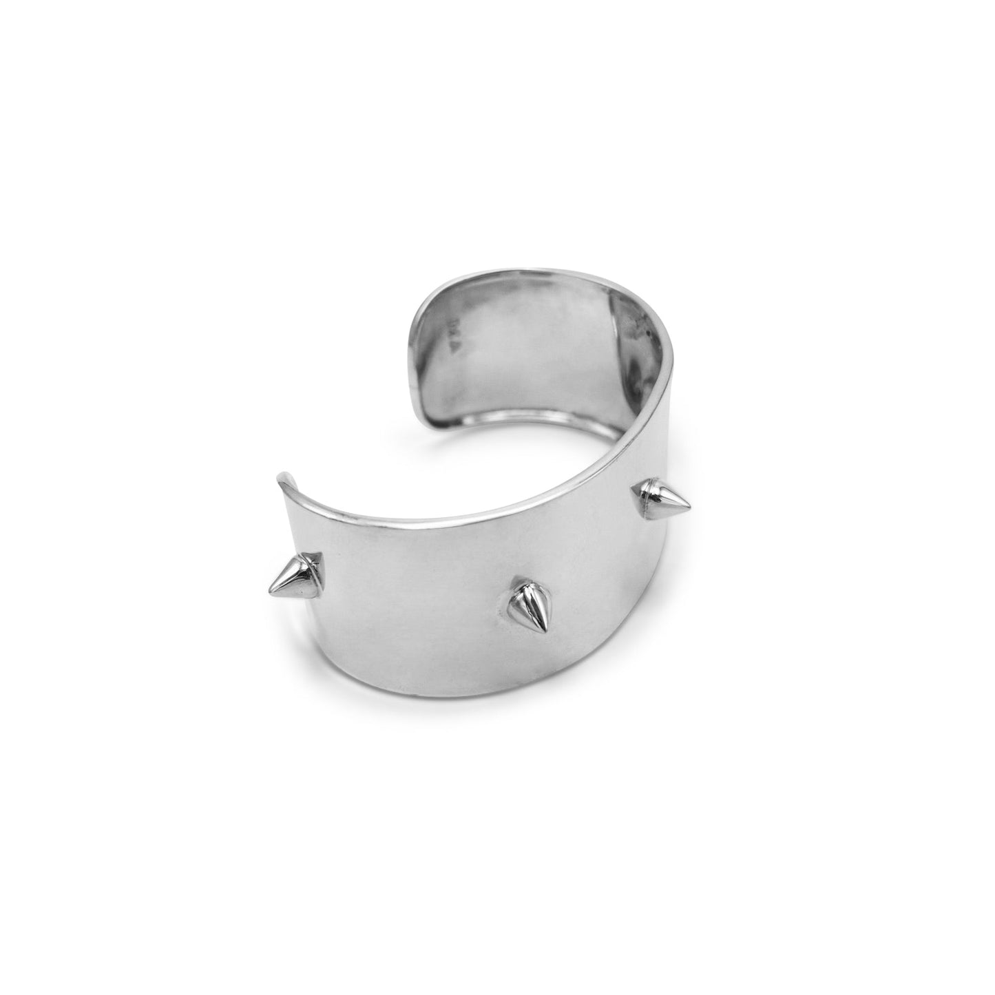 Silver cuff bracelet with spikes on a white background