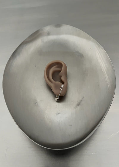 Model of a human ear on a metallic surface
