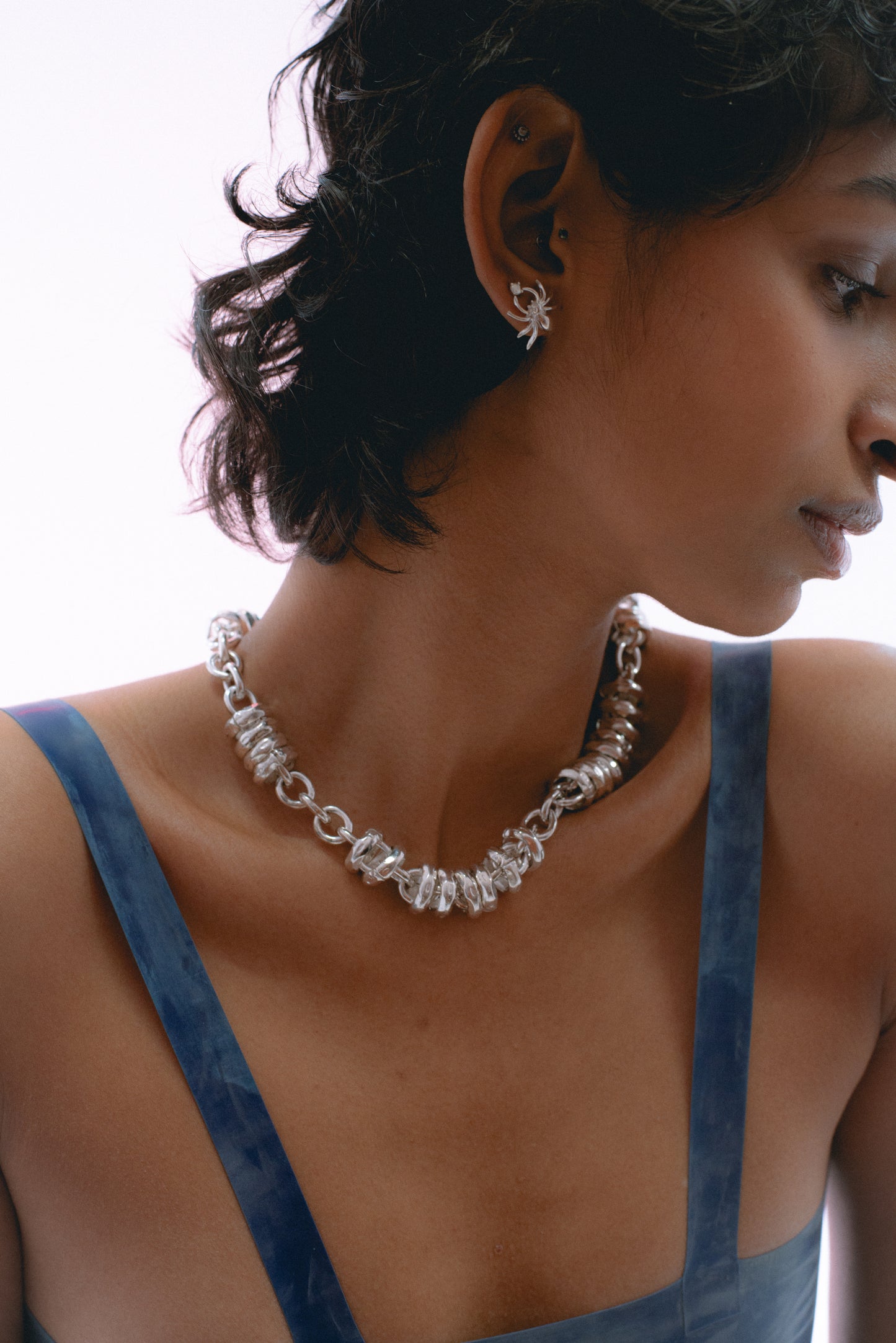 Chunky open-link chain design in heirloom silver . on model 