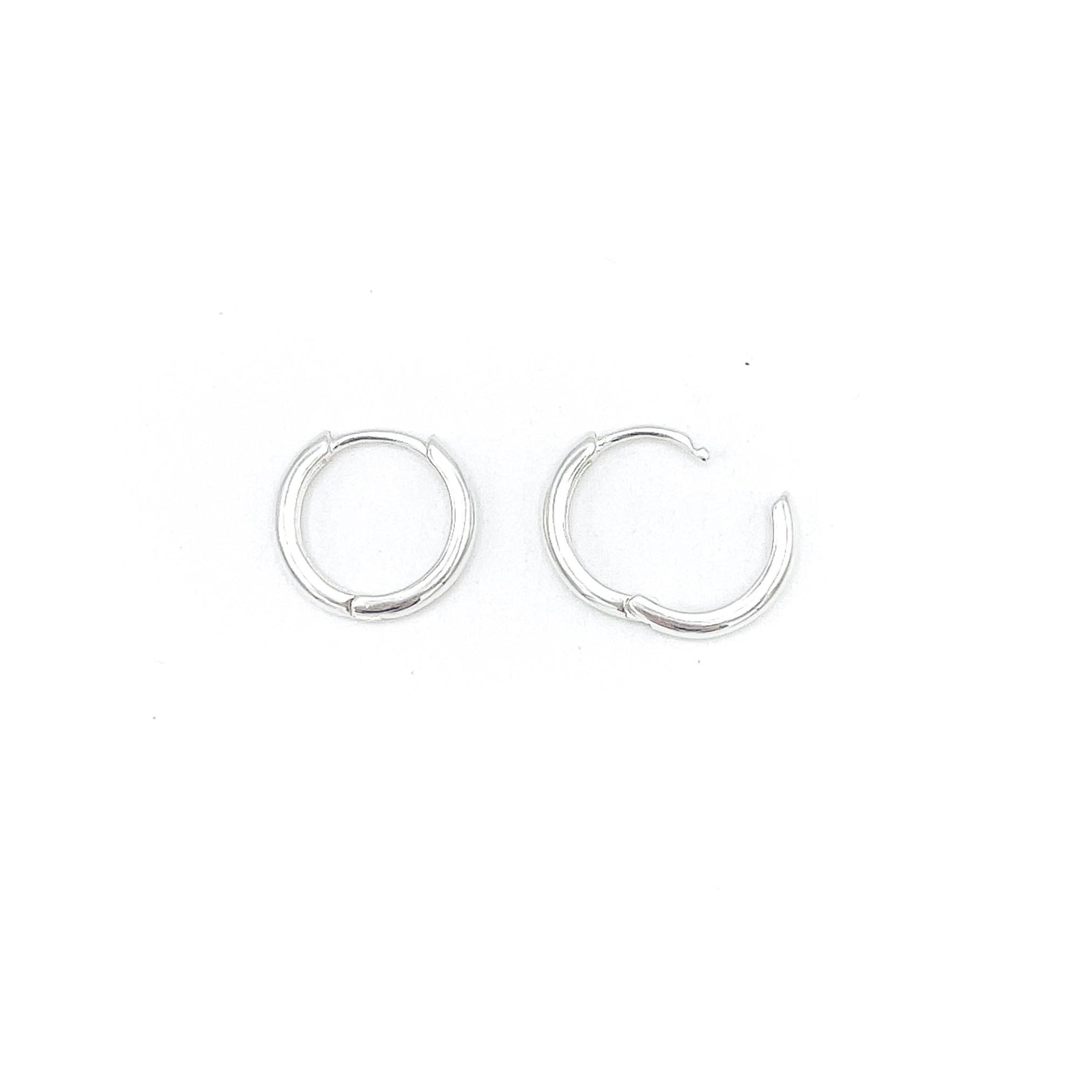 Shop Martine Ali's Signature Silver Hoops. Signature sterling silver hoop earrings (set of 2) .