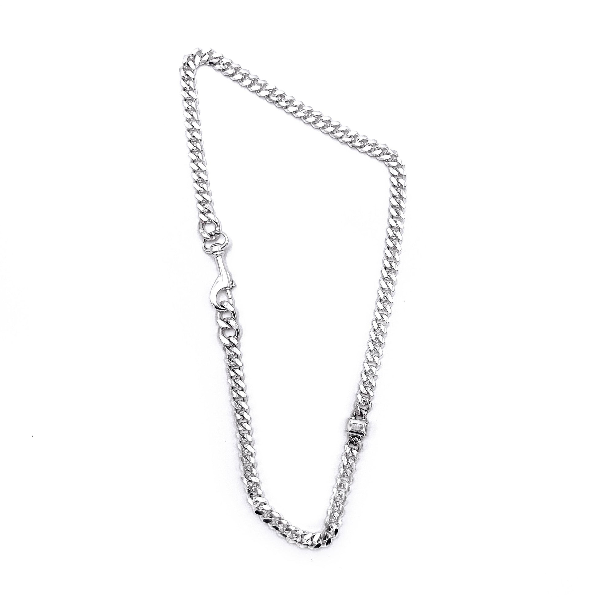 Thin link bracelet with silver stone accents .