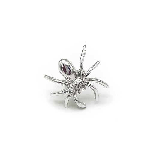 Web-inspired stud earring design in silver .
