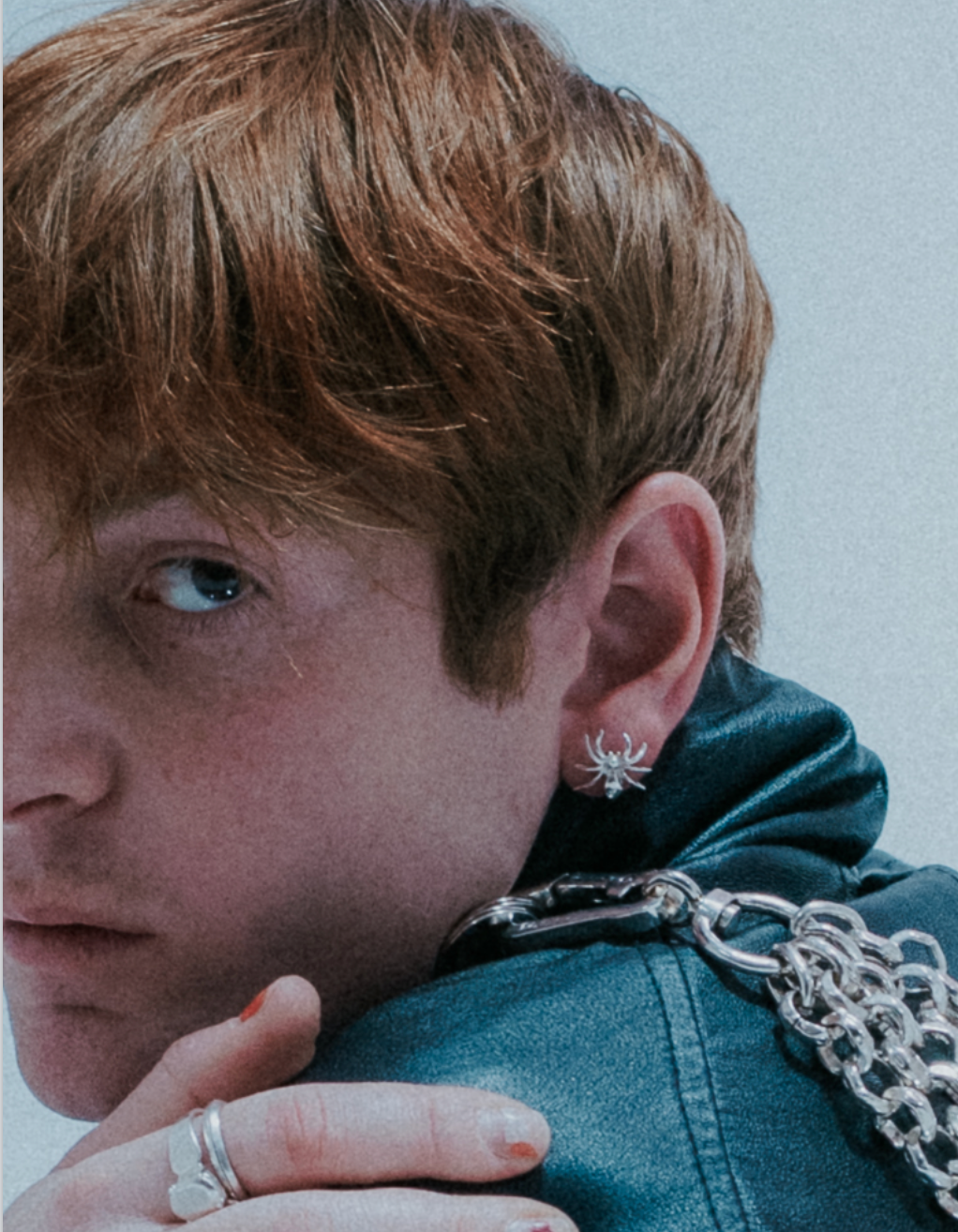 Web-inspired stud earring design in silver. On Model