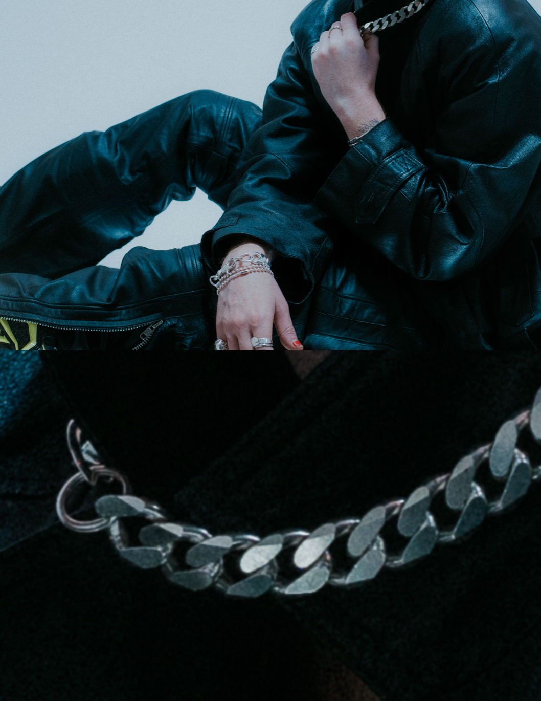 Oversized flat link chain design; bold statement piece. on model