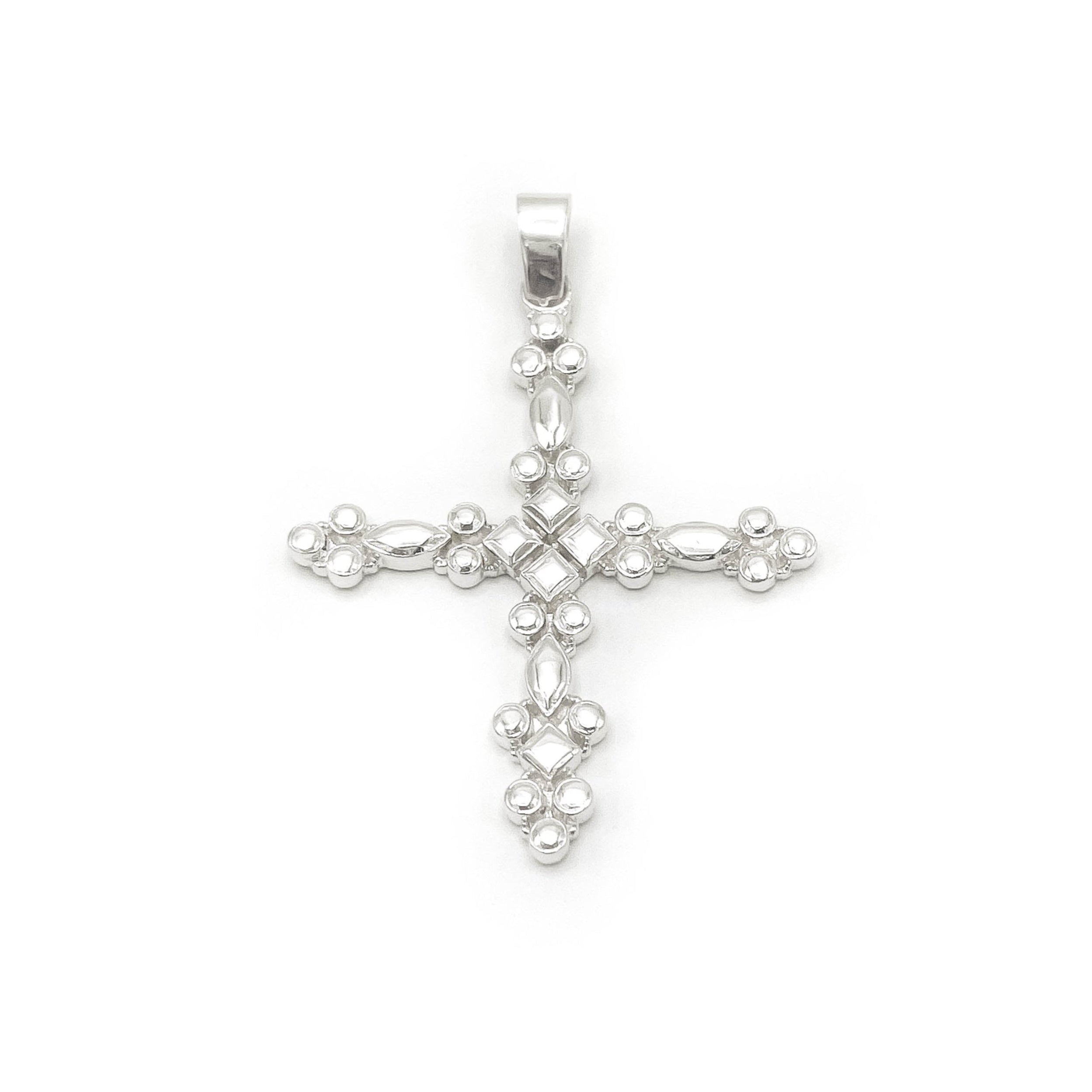 Silver cross pendant on a white background